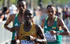 Uganda's Victor Kiplangat, Ethiopia's Leul Gebresilase, and Ethiopia's Tamirat Tola compete in the men's marathon final