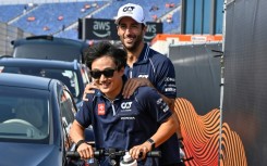 Daniel Ricciardo (right) arrives for his fateful practice session at Zandvoort on Friday on a scooter with his Alpha Tauri teammate Yuki Tsunoda 