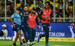 New Zealand batter Kane Williamson (second from left) had to be helped off after injuring his knee playing for Gujarat Titans in the Indian Premier League last April
