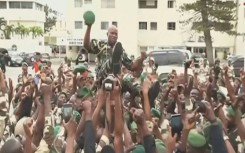 A video grab from Gabon 24 showing soldiers carrying General Brice Oligui Nguema, head of Bongo's presidential guard