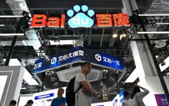Visitors walk past the Baidu booth during the World Artificial Intelligence Conference (WAIC) in Shanghai