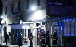 Firefighters and police officers at the train station in Brandizzo, Italy, where the maintenance workers were hit
