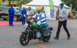 Kenyan President William Ruto takes a ride on one of the new e-bikes 