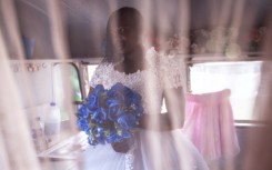 The big day: Bride-to-be Memory poses for a portrait after getting fitted for her wedding gown