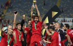 Hussein el Shahat (C) holds the CAF Champions League trophy after Al Ahly of Egypt defeated Wydad Casablanca of Morocco in the 2023 final.
