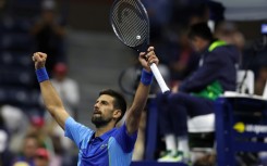 Novak Djokovic celebrates after his five-set victory in the US Open third round on Friday