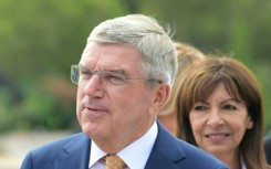 IOC president Thomas Bach (L) and Paris Mayor Anne Hidalgo on the quays of the Seine River in Paris on July 25, 2023