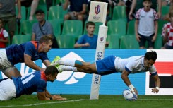 Wing Ange Capuozzo (right) dives over the line to score Italy's fourth try against Namibia