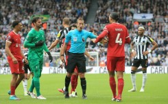 Liverpool defender Virgil van Dijk (2R) was sent off at Newcastle