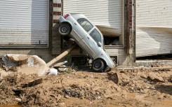 A car swept up against the side of a Benghazi building by the floodwaters