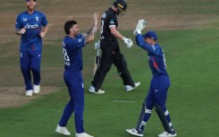 In the wickets - Reece Topley celebrates his dismissal of New Zealand's Glenn Phillips (2R) with England captain Jos Buttler (R) during the second ODI at Southampton