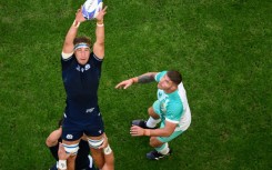 Scotland's flanker and captain Jamie Ritchie (L) grabs the ball in a line out as South Africa's hooker Malcom Marx looks on