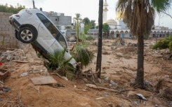 Vehicles are buried in mud and rubble in the aftermath of a devastating flood in eastern Libya's city of Derna