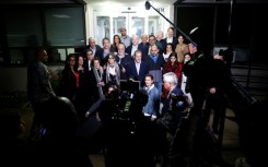 US officials arrange a group photo of the former prisoners freed by Iran landed at an airfield near Washington 