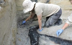 Archaeologists excavating the prehistoric wooden structure at Kalambo Falls in Zambia