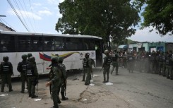 Inmates board a bus as they are transferred from the prison