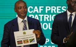Patrice Motsepe, president of the Confederation of African Football, reveals the host countries for the 2027 Africa Cup of Nations at a ceremony in Cairo 