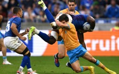 Namibia's openside flanker and captain Tjiuee Uanivi is tackled by Uruguay's scrum-half Santiago Arata during the teams Rugby World Cup clash in Lyon