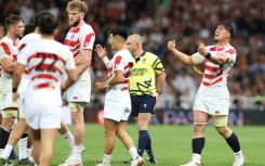Japan's number eight and captain Kazuki Himeno (R) celebrates victory over Samoa