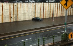 A car stranded on a flooded road in Brooklyn after heavy rains inundated New York City and the surrounding areas