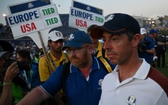 Angry: Rory McIlroy leaves the 18th green 