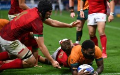 Australia wing Marika Koroibete (right) dives over to score the Wallabies' fifth try