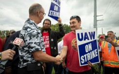 United Auto Workers President Shawn Fain greets UAW members as they strike the General Motors Lansing Delta Assembly Plant in September 2023