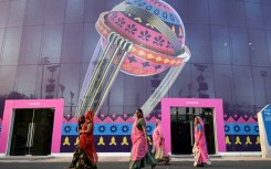 'Cricket crazy': Women along with a child walk inside the complex of the Narendra Modi Stadium 