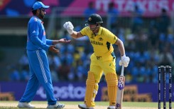 Ball boys: Australia's David Warner gives the ball to India captain Rohit Sharma on Sunday