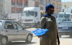 A street vendor sells plastic sachets filled with drinking water in Dakar