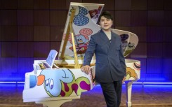 Pianist Lang Lang poses during the unveiling of the 'Steinway x Disney: Mickey Mouse Limited Edition' piano event at Steinway Hall New York in October 2023