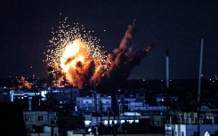 A ball of fire and smoke rise above buildings during an Israeli strike on Rafah in the southern Gaza Strip, on October 15, 2023