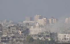 Israeli artillery fires into northern Gaza, seen from Sderot