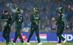 Booed: Pakistan captain Babar Azam (centre) with teammates at the end of the game against India