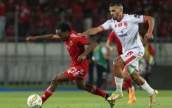 Wydad Casablanca midfielder Jalal Daoudi (R) chases Al Ahly forward Percy Tau during the second leg of the 2023 CAF Champions League final
