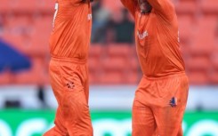 That's out: Netherlands' Paul van Meekeren (left) celebrates after taking the wicket of New Zealand's Daryl Mitchell in Hyderabad