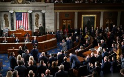 Republican members of the House of Representatives applaud as former US House speaker Kevin McCarthy speaks before a third vote to elect a new speaker on October 20, 2023