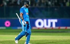 Ton up: New Zealand's Daryl Mitchell celebrates after scoring a century against India on Sunday 