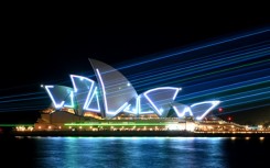 Laser beams illuminate the sails of the Sydney Opera House during celebrations to mark the building's 50th anniversary