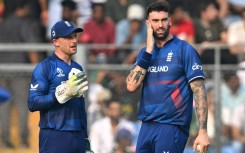All over: England captain Jos Buttler (left) speaks with Reece Topley 