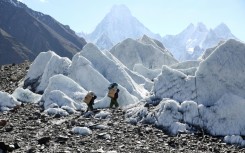 Pakistani porters hike the Baltoro Glacier, July 14, 2023