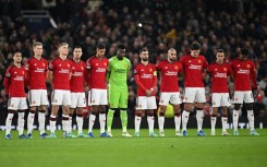 Manchester United's players observe a minute of silence to remember Bobby Charlton