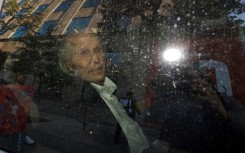 Seen through a police vehicle window, Canadian-Finnish fashion mogul Peter Nygard leaves a courthouse in Toronto. He is on trial for the alleged sexual assaults of four women and a girl between 1988 and 2005