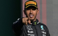 Mercedes' British driver Lewis Hamilton celebrates on the podium after placing second after the Formula One Mexico Grand Prix at the Hermanos Rodriguez racetrack in Mexico City on October 29, 2023.