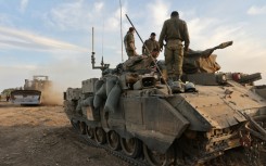 Israeli troops gather near the border with Gaza