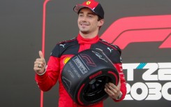 Ferrari's Monegasque driver Charles Leclerc celebrates winning the pole position after the qualifying session for the Formula One Mexico Grand Prix at the Hermanos Rodriguez racetrack in Mexico City on October 28, 2023.