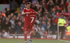 Liverpool forward Diogo Jota holds up Luis Diaz's shirt at Anfield