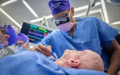 Dr. Eduardo Rodriguez operates on Aaron James in the first whole-eye and partial face transplant, at NYU Langone Health in New York