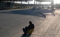One of the final asylum seekers at the Nuijamaa border crossing between Finland and Russia waits before the crossing is closed -- one of four that Finland will shut at midnight over a surge in undocumented migrants