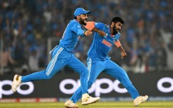 Breakthrough: India's Jasprit Bumrah celebrates with Virat Kohli after taking the wicket of Australia's Steve Smith 